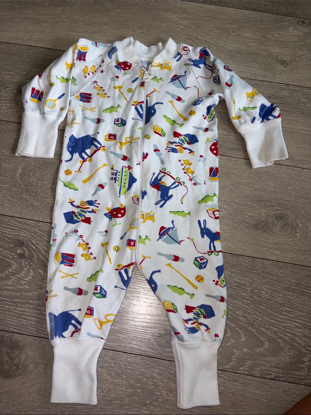 Hanna Andersson White One-Piece Footie with Colorful Toy Print